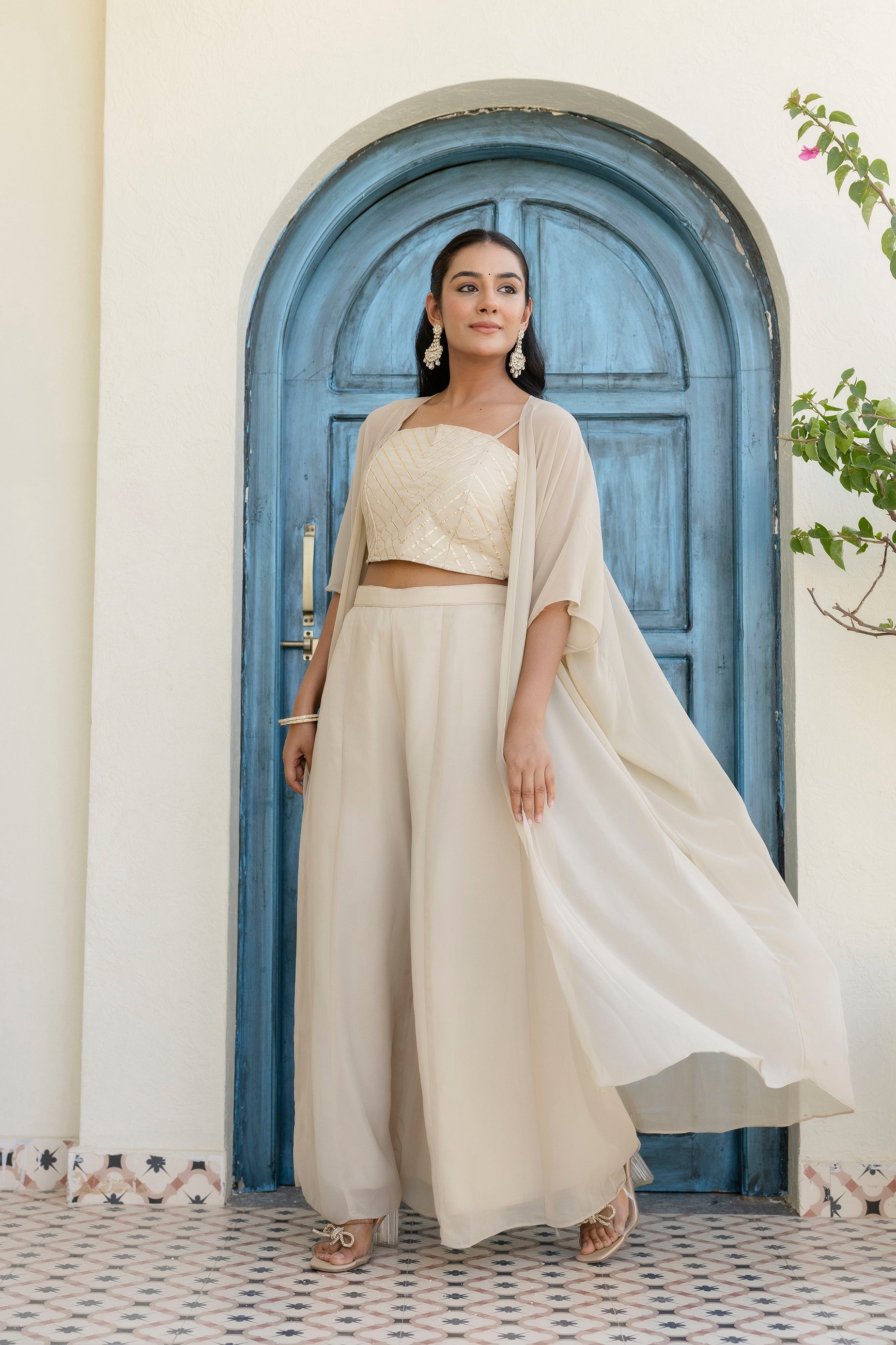 Glow in style with this ready-to-wear georgette ensemble featuring a graceful gotta patti work top, flowy palazzo, and a chic shrug
