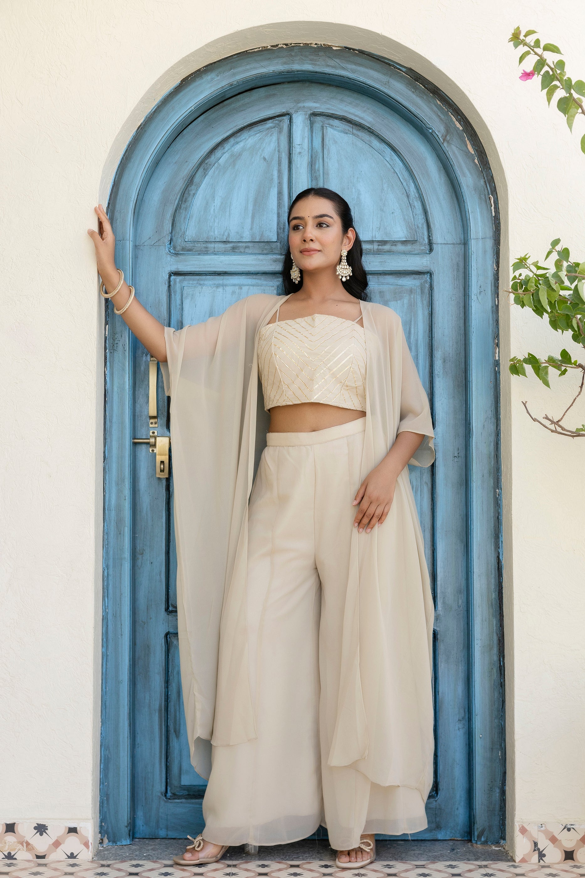 Glow in style with this ready-to-wear georgette ensemble featuring a graceful gotta patti work top, flowy palazzo, and a chic shrug