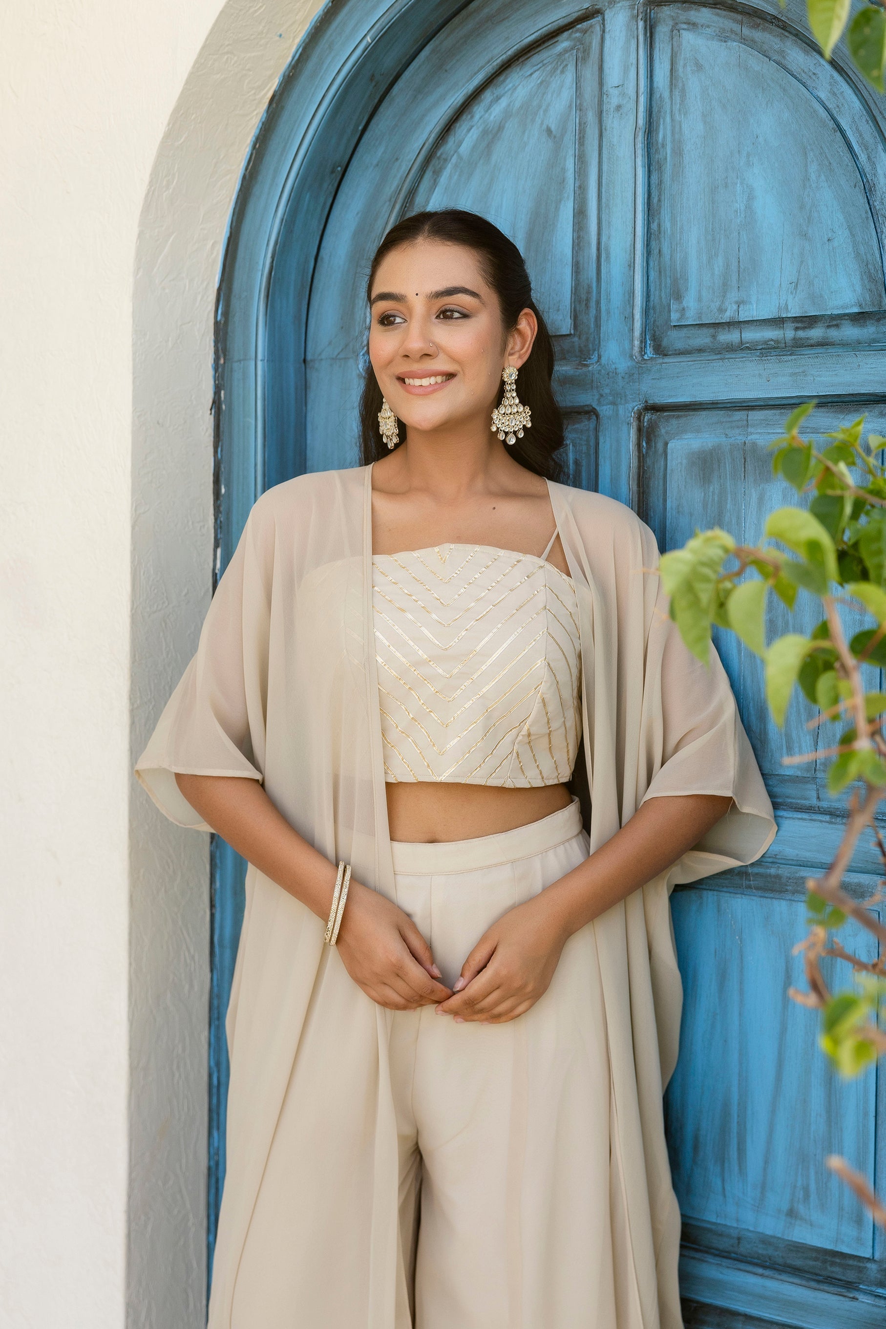 Glow in style with this ready-to-wear georgette ensemble featuring a graceful gotta patti work top, flowy palazzo, and a chic shrug