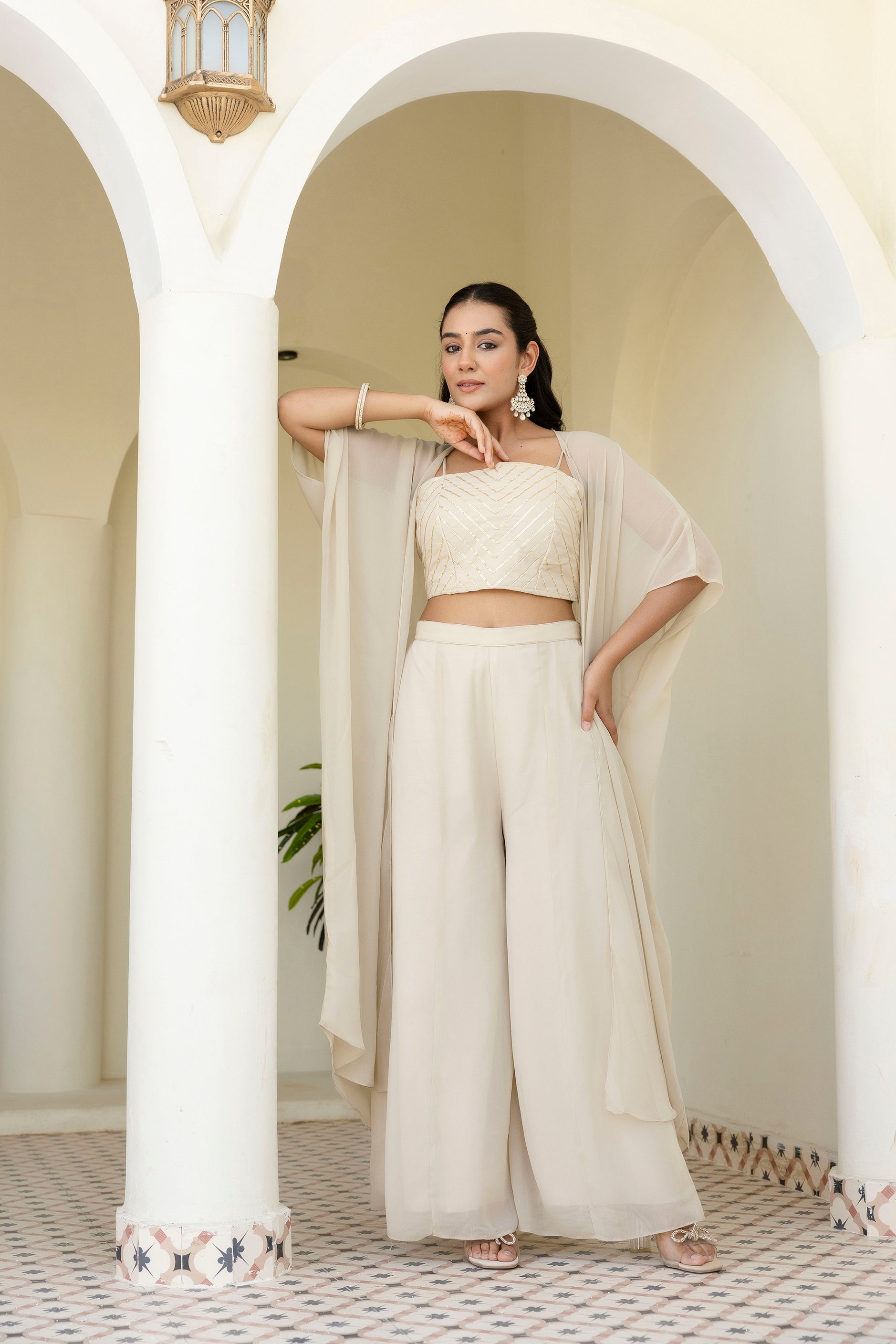 Glow in style with this ready-to-wear georgette ensemble featuring a graceful gotta patti work top, flowy palazzo, and a chic shrug