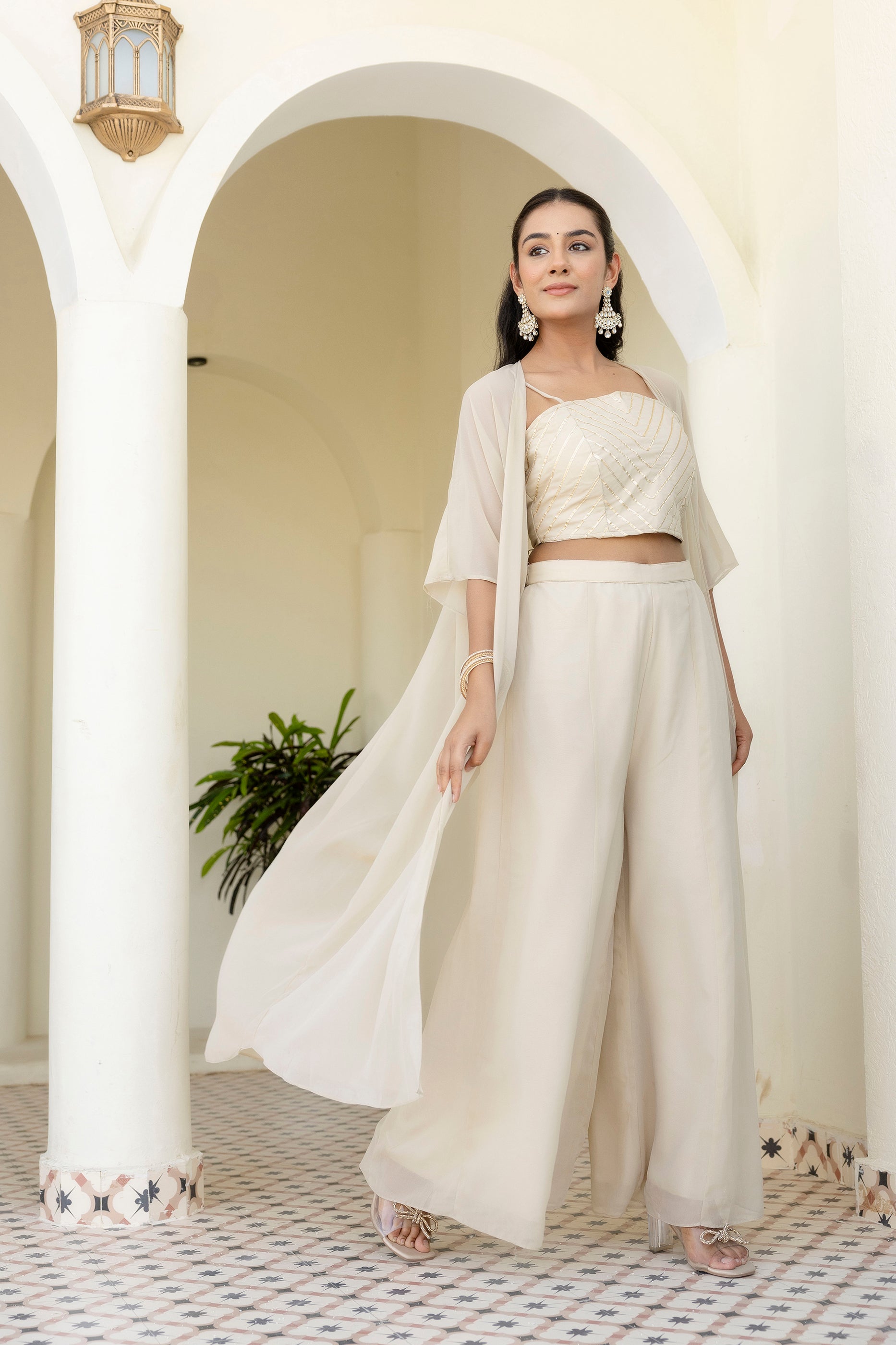 Glow in style with this ready-to-wear georgette ensemble featuring a graceful gotta patti work top, flowy palazzo, and a chic shrug